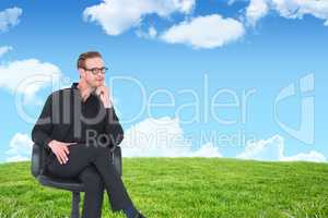 Composite image of thoughtful businessman sitting on a swivel ch