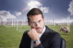 Composite image of cheerful businessman posing with hand on chin