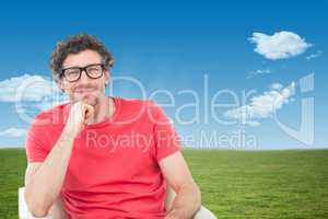 Composite image of happy businessman wearing reading glasses whi