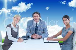 Composite image of portrait of smiling business people sitting a