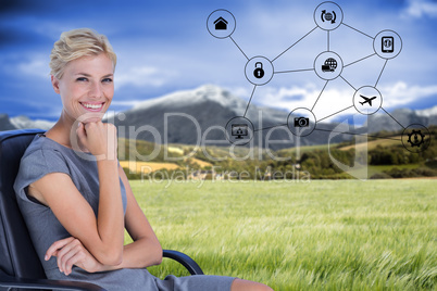 Composite image of portrait of smiling businesswoman sitting on