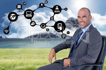 Composite image of portrait of confident businessman sitting on