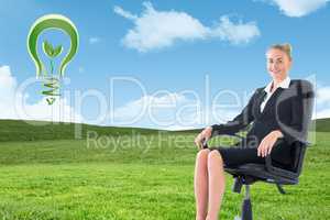 Composite image of businesswoman sitting on swivel chair in blac