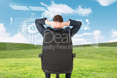 Composite image of businessman sitting in swivel chair