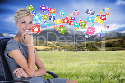 Composite image of portrait of smiling businesswoman sitting on