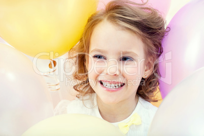 Portrait of happy child on balloons background