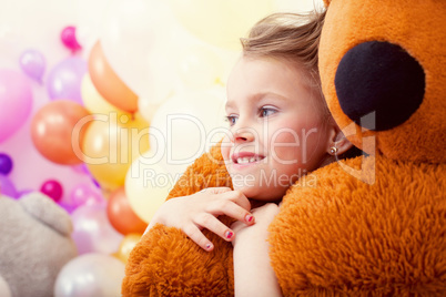 Portrait of sweet little girl hugging teddy bear