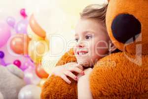 Portrait of sweet little girl hugging teddy bear