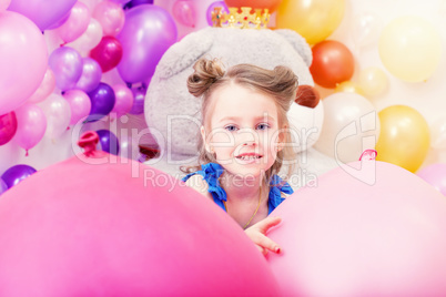 Portrait of lovely little girl posing in playroom