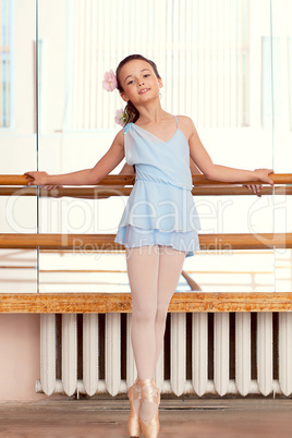 Image of petite ballerina posina at camera