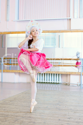 Graceful ballerina dancing in Russian costume