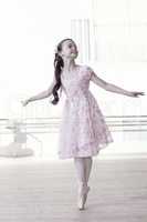 Graceful little girl dancing in ballet studio