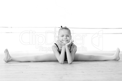 Black and white photo. Cute ballerina doing split