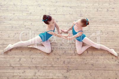 Top view of petite ballerinas dancing in studio