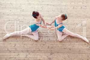 Top view of petite ballerinas dancing in studio