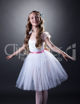 Smiling young ballerina posing at camera