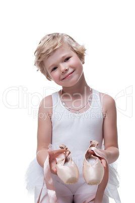 Smiling little blonde posing with pointe shoes