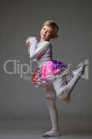 Playful little ballerina posing at camera