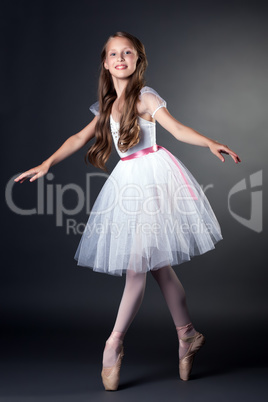 Pretty long-haired ballerina dancing in studio