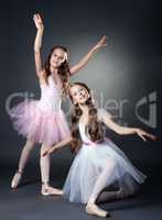 Image of two lovely ballerinas posing at camera
