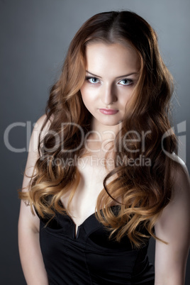 Portrait of sensual gray-eyed girl in black dress