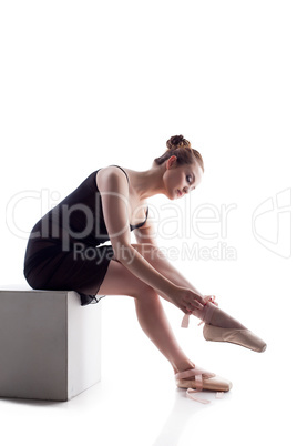 Charming young dancer puts on pointes