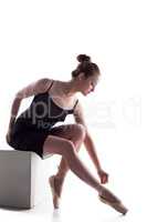 Image of beautiful young woman tying pointe