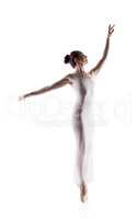 Image of slender young woman dancing on pointes