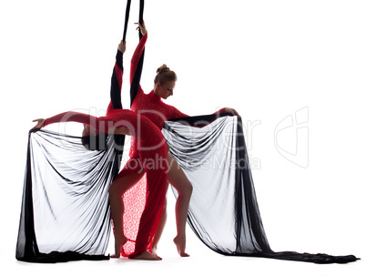 Sexy young dancers posing with silk ropes
