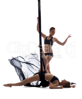 Cute athletic girls dancing with silk ropes