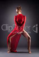 Attractive busty dancer posing in erotic dress