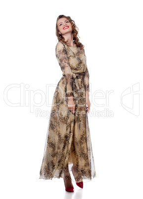 Cheerful young woman posing in stylish long dress