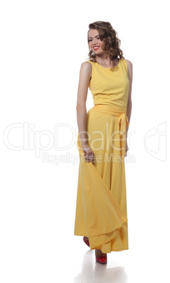 Smiling curly girl posing in stylish yellow dress