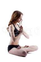 Nice young girl meditates in lotus position