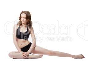 Thoughtful pretty girl doing stretching exercises