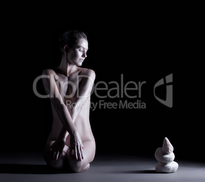 Relaxed smiling model posing with stones