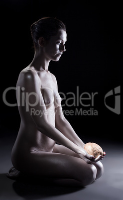 Relaxed nude woman posing with stone