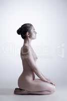 Side view of naked woman with shimmering skin