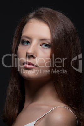 Portrait of pretty young brunette posing at camera