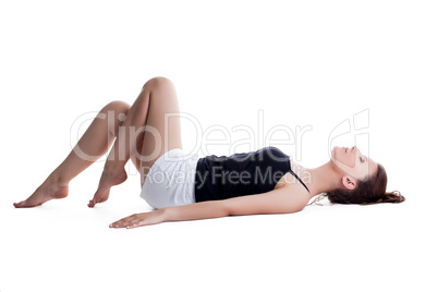 Seductive young woman posing lying in studio