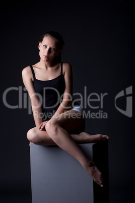 Studio shot of sexy young model sitting on cube