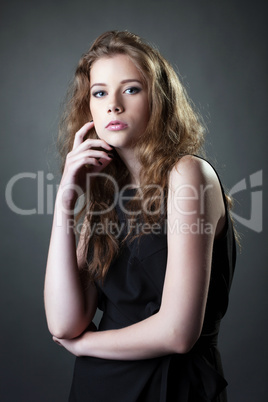 Beautiful girl posing in black casual dress