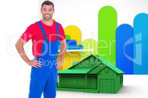 Composite image of happy handyman in overalls with hands on hip