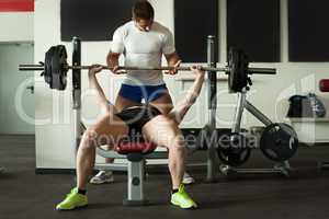 Image of two athletes exercising with barbell