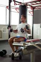 Image of muscular man exercising in gym