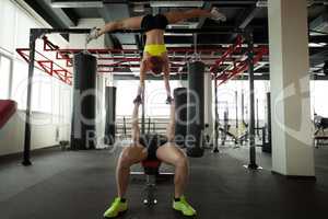 Image of flexible athletes exercising in gym