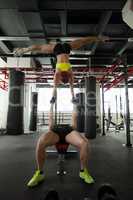 Couple of muscular acrobats training in gym
