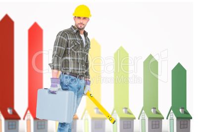 Composite image of manual worker with spirit level and toolbox