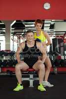 Image of smiling young athletes posing in gym