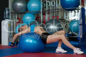 Woman doing stretching exercises on gymnastic ball